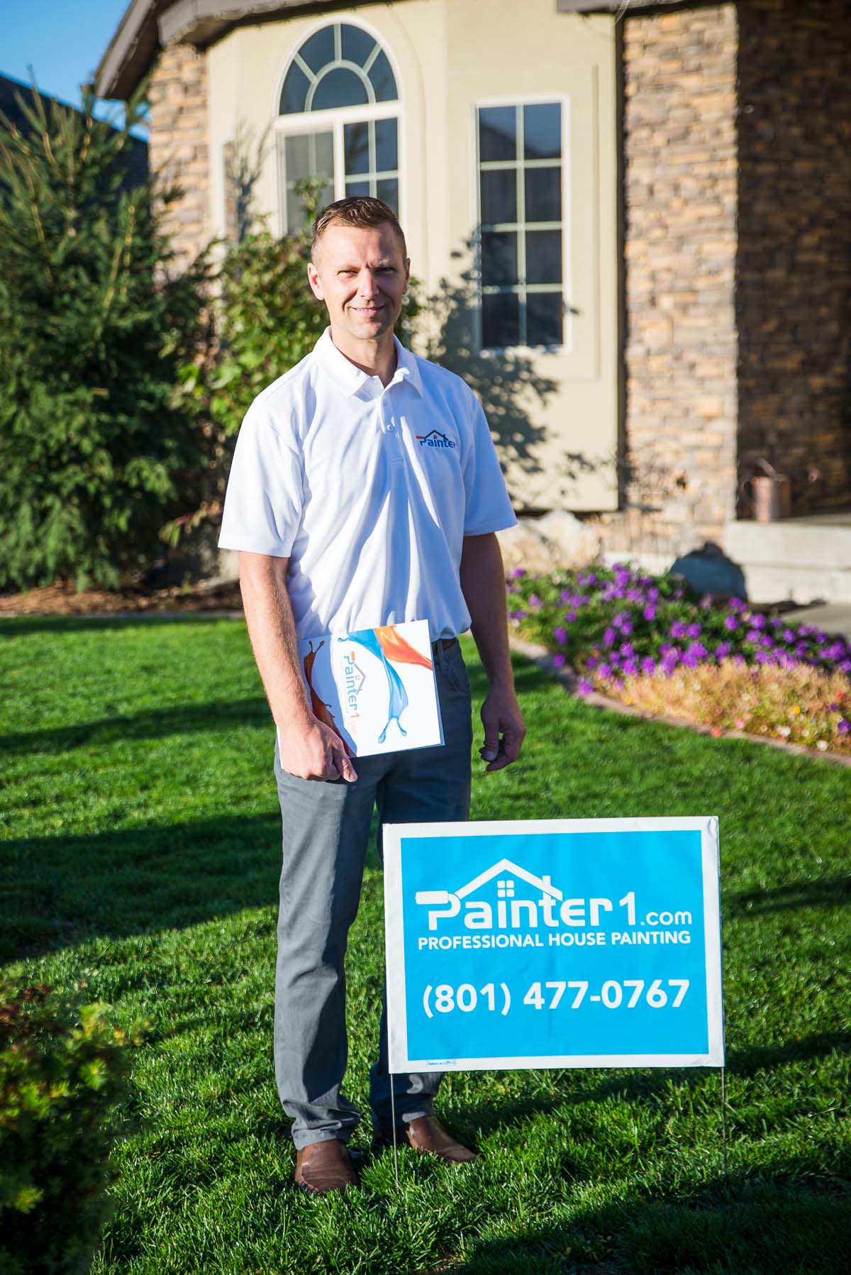 This Painter1 owner stands by a beautiful home painted by his franchise.